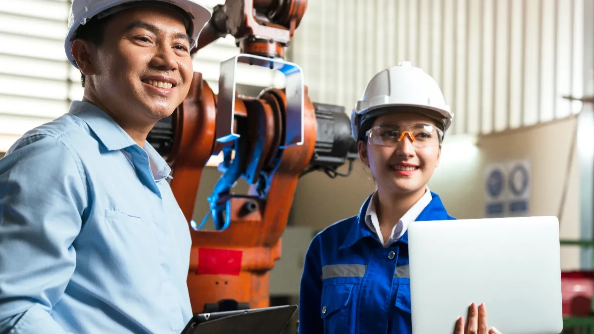 engineer-cooperation-two-asian-male-female-technician-maintenance-inspect-relay-robot-system-with-tablet-laptop-control-quality-operate-process-work-heavy-industry-40-manufacturing-factory